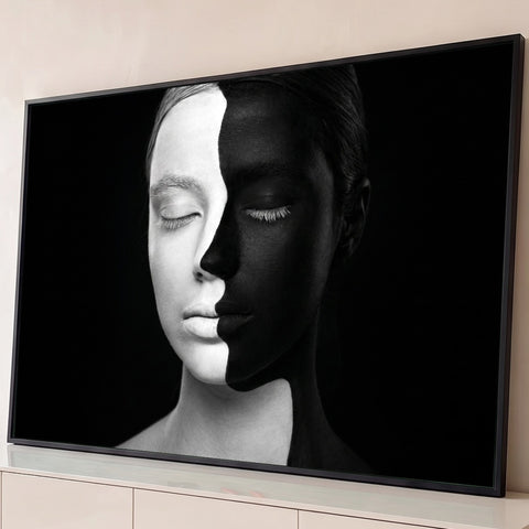 Rosto feminino metade branco metade preto em body paint, olhos fechados, fundo preto, quadro decorativo