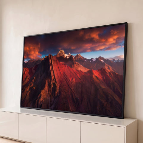 Cordilheira dos Andes vermelha com picos nevados sob céu de nuvens alaranjadas, quadro decorativo