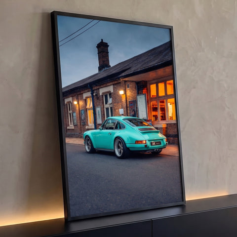 Porsche 911 clássico verde menta estacionado diante de estação de tijolos ao entardecer, quadro decorativo