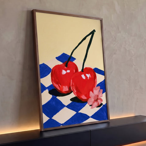 Quadro Decorativo Grande Cerejas Vermelhas para Área Gourmet | quadros decorativos para sala | duas cerejas vermelhas unidas sobre tecido xadrez azul e flor rosa | Porao dos Quadros