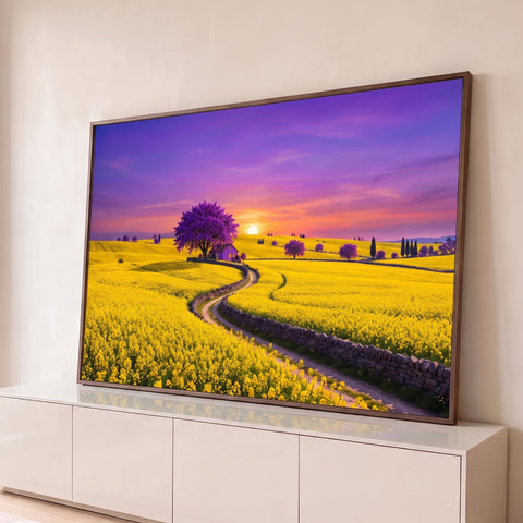 Campo de flores amarelas com caminho de pedra, ipê roxo, casinha e pôr do sol lilás, quadro decorativo