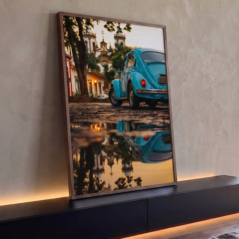 Fusca azul antigo refletido em poça numa rua de pedra com igreja colonial ao entardecer, quadro decorativo