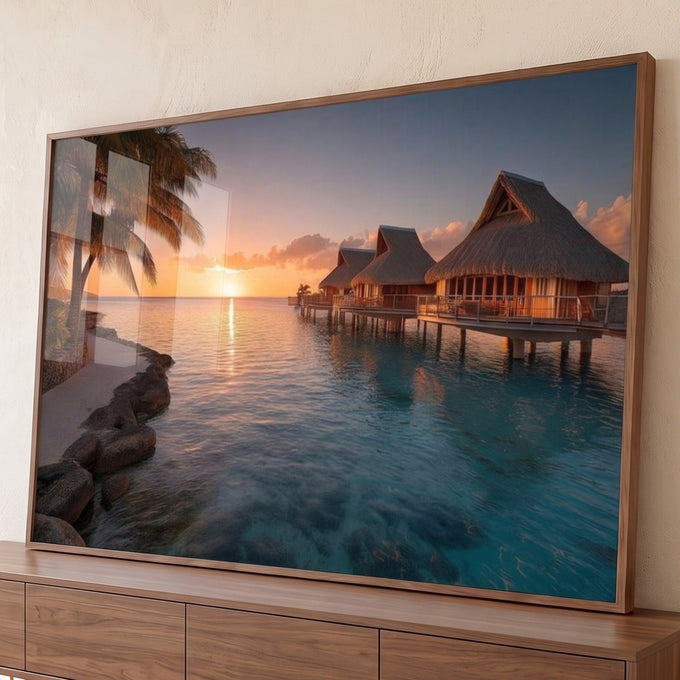 Praia tropical com bangalôs sobre o mar turquesa, palmeiras e pôr do sol dourado, quadro decorativo
