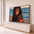 Quadro Decorativo Grande Menina com Poncho para Sala Azul | quadros decorativos para sala | menina de cabelos escuros com poncho colorido à beira-mar ao pôr do sol | em Quadros para Sala | Porao dos Quadros