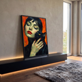 Quadro Decorativo Mulher com Gato Preto em Fundo Laranja | quadros decorativos para sala | mulher de olhos fechados segurando gato preto de olhos amarelos em fundo laranja | em Quadros para Sala | Porao dos Quadros