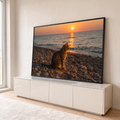 Quadro Decorativo Grande Gato Observando para Sala Laranja | quadros decorativos para sala | gato tabby sentado em praia de seixos observando o pôr do sol dourado no mar | em Quadros para Sala | Porao dos Quadros