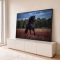 Quadro Decorativo Grande Cavalo Correndo Preto para Sala | quadros decorativos para sala | cavalo preto de crina longa correndo em campo de flores vermelhas sob céu nublado | em Quadros para Sala | Porao dos Quadros