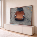 Quadro Decorativo Grande Carro Laranja Metálico para Sala | quadros decorativos para sala | carro esportivo laranja metálico fotografado de frente sobre piso de concreto | em Quadros para Sala | Porao dos Quadros