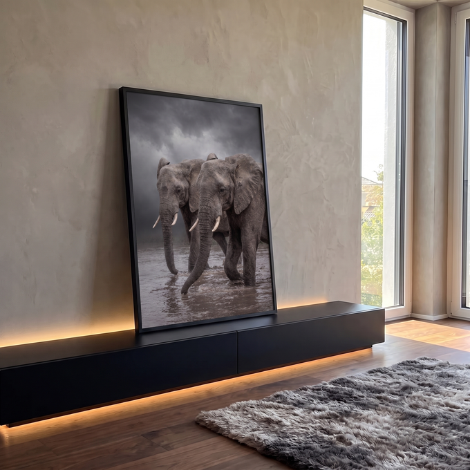 Dois elefantes africanos cruzando rio barrento sob céu de tempestade em tons de cinza, quadro decorativo