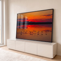 Quadro Decorativo Grande Flamingos Alçando para Sala Laranja | quadros decorativos para sala | flamingos em silhueta alçando voo sobre lago durante pôr do sol vermelho e laranja | em Quadros para Sala | Porao dos Quadros