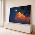Quadro Decorativo Grande Lua Cheia e Nuvem para Sala Azul | quadros decorativos para sala | lua cheia branca ao lado de nuvem alaranjada com galhos verdes em céu noturno azul | em Quadros para Sala | Porao dos Quadros