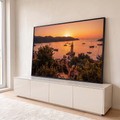 Quadro Decorativo Grande Farol ao Pôr do Sol para Sala | quadros decorativos para sala | farol branco entre veleiros em baía ao pôr do sol laranja | em Quadros para Sala | Porao dos Quadros