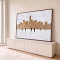 Pintura de prédios em tons bege com silhuetas de pessoas e reflexos sobre fundo branco, quadro decorativo