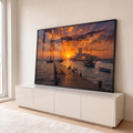Quadro Decorativo Grande Cais Veleiros para Sala Laranja | quadros decorativos para sala | cais de madeira ao pôr do sol com cachorro, bicicleta e veleiros ao fundo | em Quadros para Sala | Porao dos Quadros