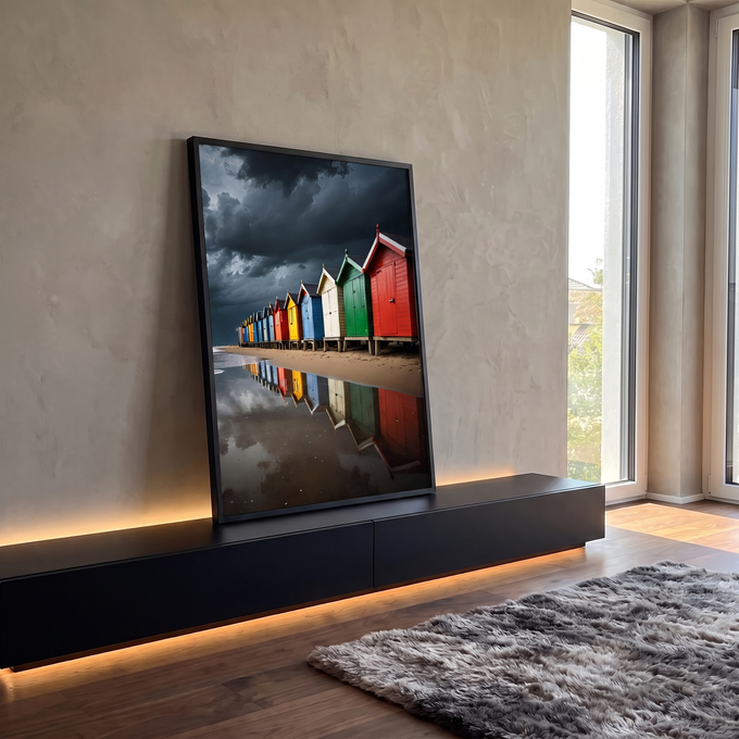 Casinhas de praia coloridas refletidas na areia molhada sob céu escuro de tempestade, quadro decorativo