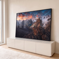 Quadro Decorativo Grande Viajante Contemplando para Sala | quadros decorativos para sala | pessoa sentada em penhasco observando cordilheira nevada e pôr do sol alaranjado | em Quadros para Sala | Porao dos Quadros
