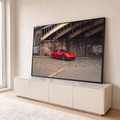 Quadro Decorativo Grande Carro Esportivo Urbano para Sala | quadros decorativos para sala | carro esportivo vermelho com rodas douradas sob ponte de ferro e muro grafitado | em Quadros para Sala | Porao dos Quadros
