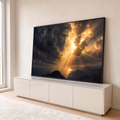 Quadro Decorativo Grande Rosto Divino Dourado para Sala | quadros decorativos para sala | rosto divino nas nuvens com raios de luz e cruz sobre penhasco ao entardecer | em Quadros para Sala | Porao dos Quadros