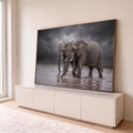Quadro Decorativo Grande Dois Elefantes para Sala Cinza | quadros decorativos para sala | dois elefantes caminhando pela água sob céu nublado dramático em tons de cinza | em Quadros para Sala | Porao dos Quadros