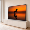 Quadro Decorativo Grande Cavalo Empinado Silhueta para Sala | quadros decorativos para sala | silhueta de cavalo empinado refletida na água sob céu laranja de pôr do sol | em Quadros para Sala | Porao dos Quadros