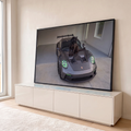Quadro Decorativo Grande Pantera Carro Esportivo para Sala | quadros decorativos para sala | pantera negra sentada sobre capô de carro esportivo cinza com faróis verdes | em Quadros para Sala | Porao dos Quadros