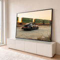 Porsche 911 clássico preto rebaixado, com trem de contêineres passando ao pôr do sol, quadro decorativo