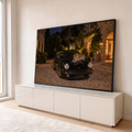 Quadro Decorativo Grande Leopardo sobre Carro para Sala | quadros decorativos para sala | leopardo deitado sobre capô de carro esportivo preto em cena noturna | em Quadros para Sala | Porao dos Quadros