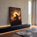 Quadro Decorativo Grande Jesus Pastor Laranja para Sala | quadros decorativos para sala | Jesus ajoelhado abraçando um cordeiro branco sob pôr do sol dourado com três cruzes ao fundo | em Quadros para Sala | Porao dos Quadros