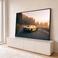 Lamborghini amarela em estrada de montanha com pinheiros e névoa dourada ao pôr do sol, quadro decorativo