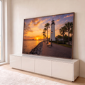 Quadro Decorativo Grande Farol Branco para Sala Laranja | quadros decorativos para sala | farol branco ao pôr do sol com palmeiras e calçadão à beira-mar | em Quadros para Sala | Porao dos Quadros