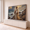 Quadro Decorativo Grande Jesus com Cordeiro Mar para Sala | quadros decorativos para sala | homem de manto segura cordeiro branco em rochas à beira-mar com céu dourado | em Quadros para Sala | Porao dos Quadros