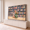 Quadro Decorativo Grande Mulher Lendo Verde para Sala | quadros decorativos para sala | mulher loira sentada lendo livro diante de estante colorida de livros | em Quadros para Sala | Porao dos Quadros