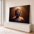 Quadro Decorativo Grande Buda em Meditação para Sala Dourado | quadros decorativos para sala | busto de estátua de Buda em bronze escuro com luz dourada e partículas suspensas | em Quadros para Sala | Porao dos Quadros