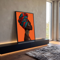 Quadro Decorativo Mulher Africana de Turbante Estampado | quadros decorativos para sala | mulher negra de perfil com turbante estampado vermelho e azul sobre fundo laranja | em Quadros para Sala | Porao dos Quadros