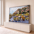 Vasos de cerâmica com limões em terraço de azulejo azul e a vila colorida de Positano ao fundo, quadro decorativo