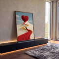 Coração vermelho gigante no topo de duna branca com caminho de tecido e figura caminhando, quadro decorativo