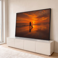 Quadro Decorativo Grande Casal e Cachorro para Sala Laranja | quadros decorativos para sala | casal abraçado e cachorro na praia durante pôr do sol laranja com veleiros ao fundo | em Quadros para Sala | Porao dos Quadros