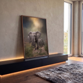 Manada de elefantes caminhando por trilha de terra na savana sob névoa e luz dourada, quadro decorativo