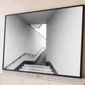 Fotografia preto e branco de escada de concreto com corrimão entre paredes claras, quadro decorativo