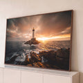 Quadro Decorativo Grande Farol Mar para Sala Laranja | quadros decorativos para sala | farol branco em rochas no mar com céu alaranjado ao pôr do sol | Porao dos Quadros
