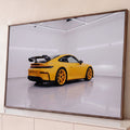 Quadro Decorativo Grande Carro Automóvel para Sala Amarelo | quadros decorativos para sala | carro esportivo amarelo visto de trás em estúdio branco com piso espelhado | Porao dos Quadros