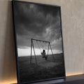 Criança sozinha em balanço num campo sob nuvens de tempestade, fotografia preto e branco, quadro decorativo