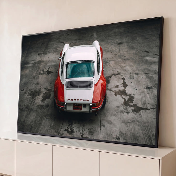Porsche 911 clássico vermelho e branco visto de cima sobre piso de concreto cinza, quadro decorativo