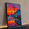 Rua molhada ao pôr do sol com casa azul, postes e céu laranja refletido na poça, quadro decorativo
