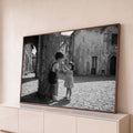 Foto preto e branco de menino e menina dividindo sorvete em rua de vila italiana, quadro decorativo