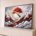 Árvore de copa vermelha diante de sol branco, nuvens cinzas em relevo e rio colorido, quadro decorativo