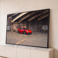 Quadro Decorativo Grande Carro Esportivo Urbano para Sala | quadros decorativos para sala | carro esportivo vermelho com rodas douradas sob ponte de ferro e muro grafitado | Porao dos Quadros