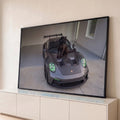 Quadro Decorativo Grande Pantera Carro Esportivo para Sala | quadros decorativos para sala | pantera negra sentada sobre capô de carro esportivo cinza com faróis verdes | Porao dos Quadros