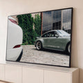Porsche 911 clássico verde-sálvia com rodas vintage diante de parede com hera e prédio de vidro, quadro decorativo