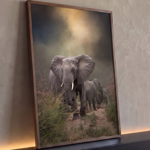 Manada de elefantes caminhando por trilha de terra na savana sob névoa e luz dourada, quadro decorativo